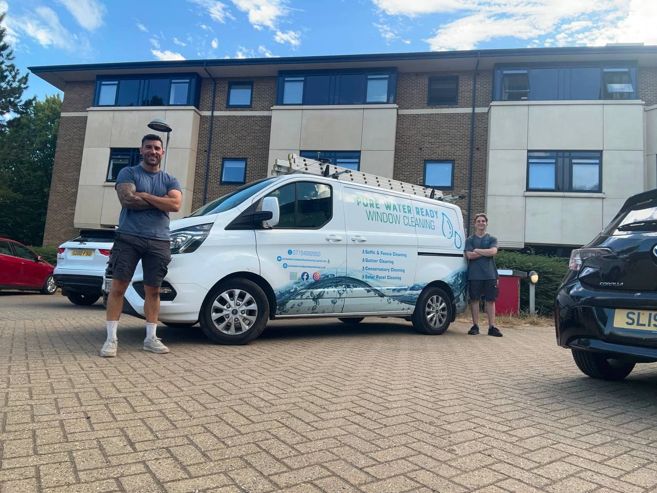 Chris and a team member beside the branded van