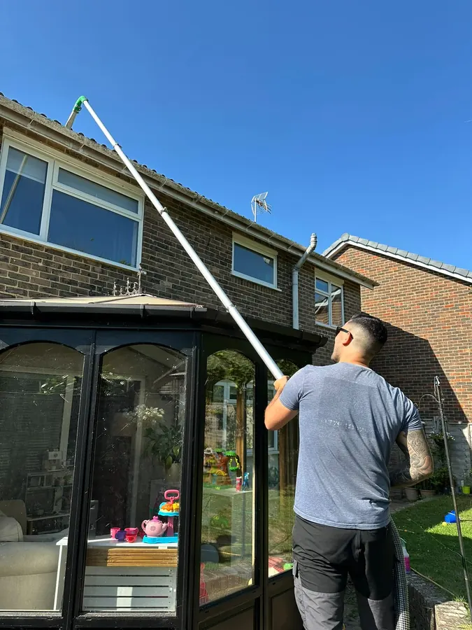 Cleaning gutters above a conservatory roof