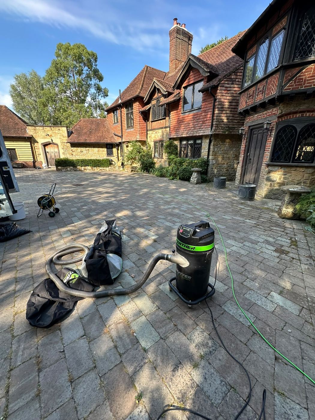 Gutter vacuum equipment set up outside a large property