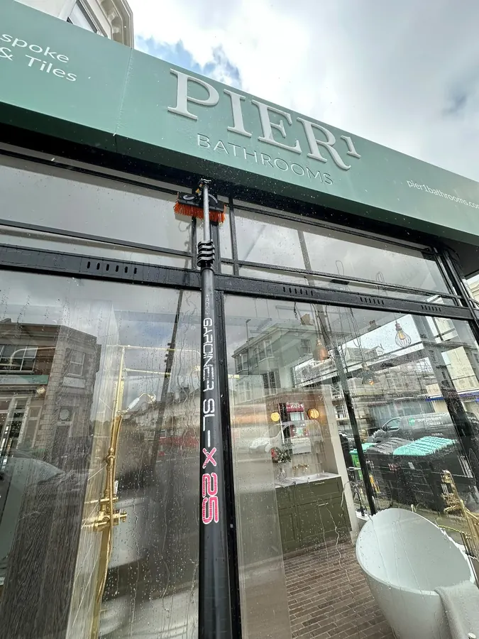 Cleaning the glass shopfront of Pier1 Bathrooms