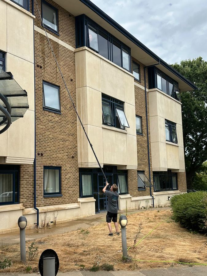 Chris using the water-fed pole to clean a three-storey building