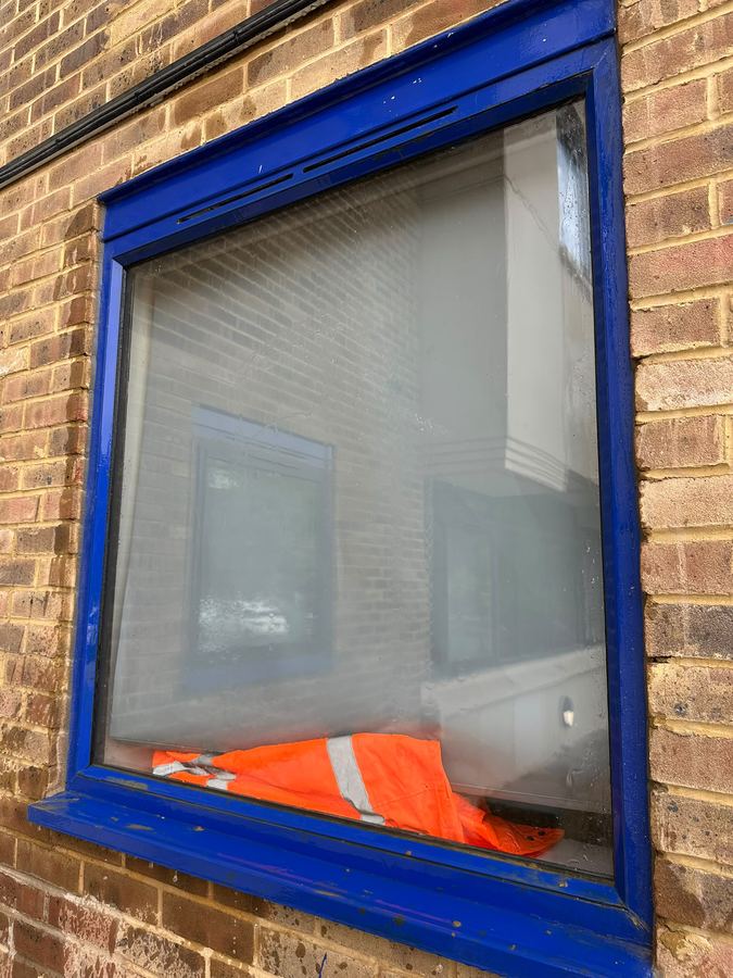 Close-up of a window frame being cleaned